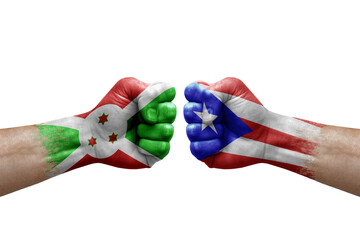 Two hands punch to each others on white background. Country flags painted fists, conflict crisis concept between burundi and puerto rico