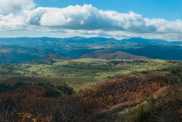 Mountain scenery with green and red forests