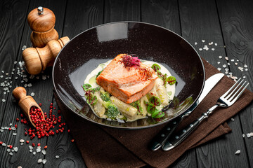 Grilled salmon steak in a creamy sauce.