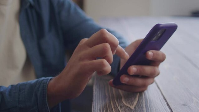 A young man is looking to the camera and smiling 