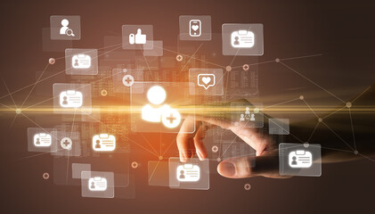 Hand pressing social media multimedia application screen with media icons on futuristic concept