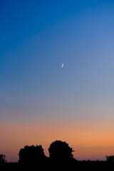 sky in dark blue twilight, Twilight sky in the evening with sunset and beautiful sunlight on a dark cloud and a crescent moon