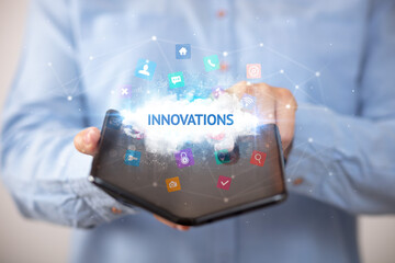 Businessman holding a foldable smartphone, technology concept