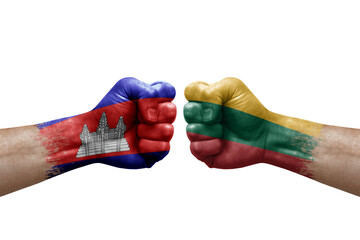 Two hands punch to each others on white background. Country flags painted fists, conflict crisis concept between cambodia and lithuania