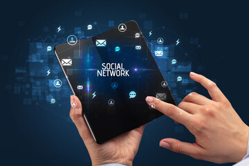 Businessman holding a foldable smartphone, social media concept