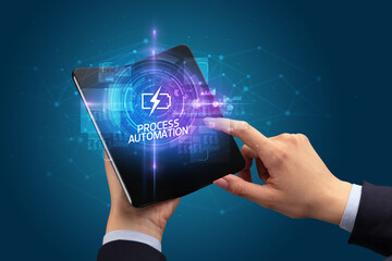 Businessman holding a foldable smartphone, technology concept