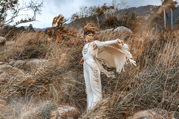 Beautiful young woman in ethnic dress on a field