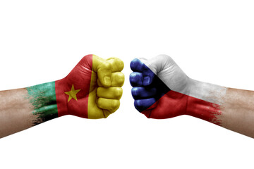 Two hands punch to each others on white background. Country flags painted fists, conflict crisis concept between cameroon and czechia