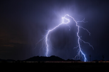 Dramatic thunderstorm lightning strike over a mountain