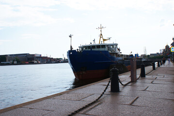 The ship is moored on the waterfront near the shipyard, a cargo ship.