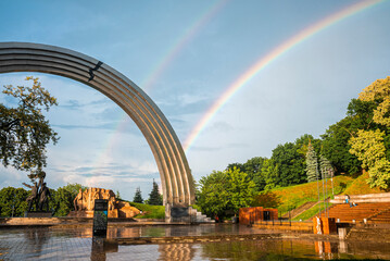 Obraz na płótnie Canvas Kyiv, Ukraine. July 20, 2021. Beautiful rainbow over the city next to People's Friendship Arch located in the Groin park on the right bank of the Dnieper
