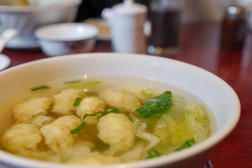 Selective focus at dumpling on wonton hot Chinese soup. 