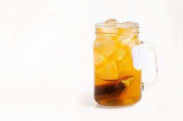 Iced tea in glass with tea bag isolate don white background.