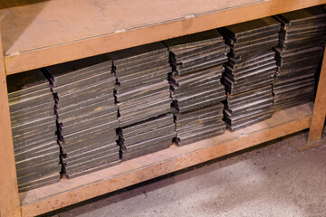 Plate metal profiles laid on top of each other in a rack.