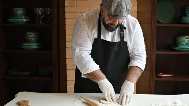 Chef makes a flapjack with his hands and smiles