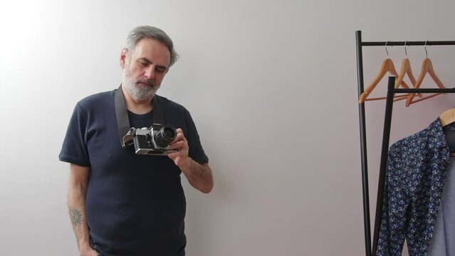 Man in his 40s posing with the film camera . High quality 4k footage