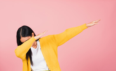Asian happy portrait beautiful cute young woman teen smile standing move showing DAB dance against...