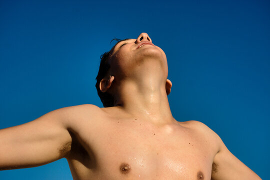 Young happy man under the sunny blue sky