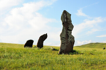 A group of tall gravestones of an ancient civilization in a picturesque hilly steppe.