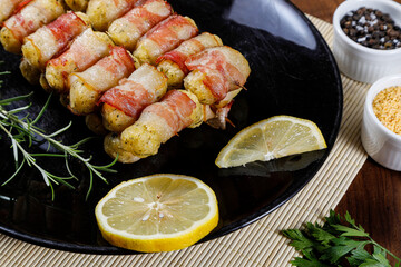 Cassava skewers wrapped in bacon, cassava medallion.