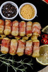 Cassava skewers wrapped in bacon, cassava medallion.