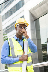 Engineer Worker Wearing Hard Hat. Happy Successful. Portrait of young African man wearing yellow hard hat helmet. Worker Wearing Safety Vest and Hard Hat 