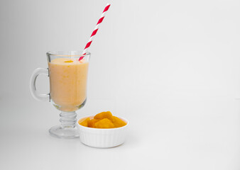 Yellow Indian mango yoghurt drink Mango Lassi or smoothie with turmeric and saffron.