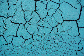 Cracked and damaged painted surface of a building or wall. Texture, aged paint background