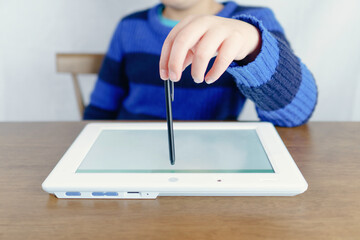 Elementary school boy using a tablet device.