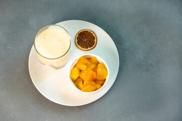 Yellow Indian mango yoghurt drink Mango Lassi or smoothie with turmeric and saffron.