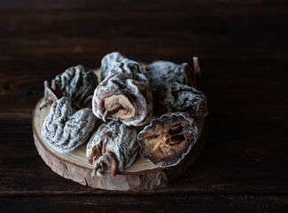 Dried persimmon on a wooden background. Healthy diet