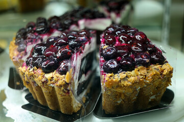 cake with a lot of blueberries is on display.