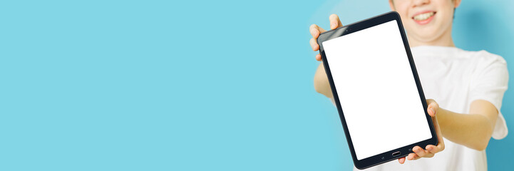 Happy smiling boy showing smartphone mockup in a blue backdrop. mobile phone , tablet screen mockup