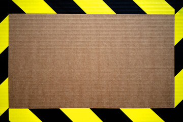 The frame is made of yellow ribbon with black color. A clean cardboard background with a yellow...