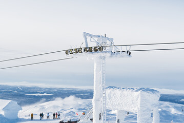 frozen funicular support poles over clouds. ski lift technology in winter, ski resort, mountain resort.