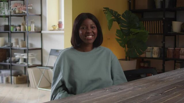 A lady is looking at the camera and smiling