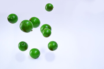 A lot of lemons falling, with white background.