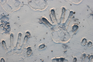 Close up top view of handprints on a sand land