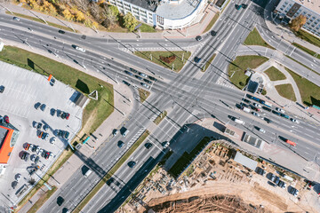 aerial view of crossroad with car traffic in industrial zone. city infrastructure from above.