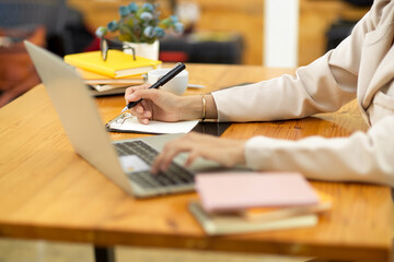 Cropped, close-up, Female assistant working on laptop computer