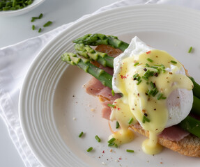 Close up view of a serving of eggs benedict ready for eating.