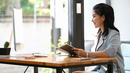 Female secretary working at her office desk