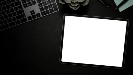 Modern office desk with tablet white screen mockup on black background.
