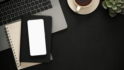 Obraz na płótnie Canvas Working space with laptop, smartphone mockup on black background.