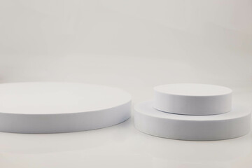 White background with white pallet props and green pine leaves. Background product. texture background Ideal backdrop for product presentations, exhibitions and mockups.