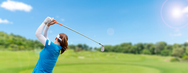 Professional woman golfer teeing golf in golf tournament competition at golf course for winner.