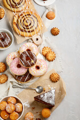Desserts assortment on light background.