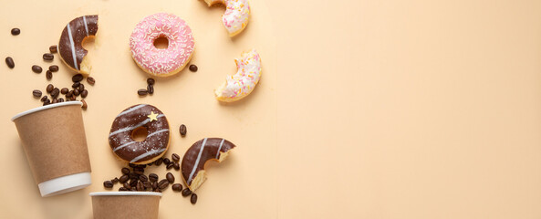 Donuts with coffee on yellow background.