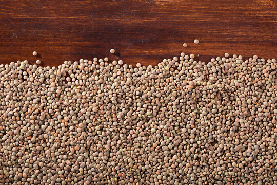 Raw lentils on a wooden surface. High quality photo