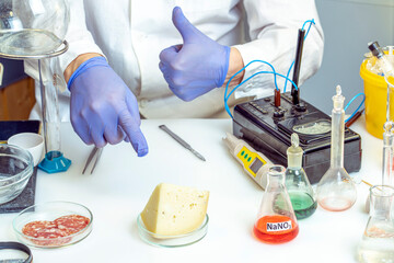 The food inspector gives a thumbs up gesture, indicating that there are no harmful additives in the cheese. Store food analysis laboratory.